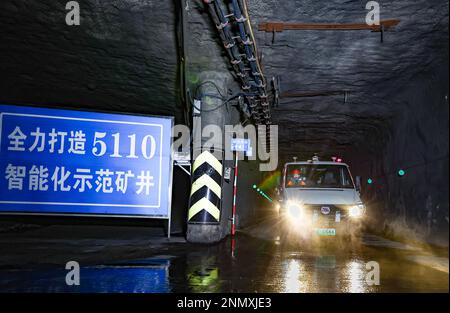 ORDOS, CHINA - FEBRUARY 24, 2023 - A new energy trackless rubber wheel vehicle equipped with a driverless system runs underground at the Shendong Coal Stock Photo