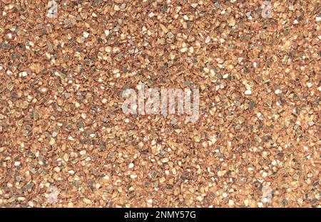 Abstract blurred background of small pebbles in orange and brown. Stock Photo