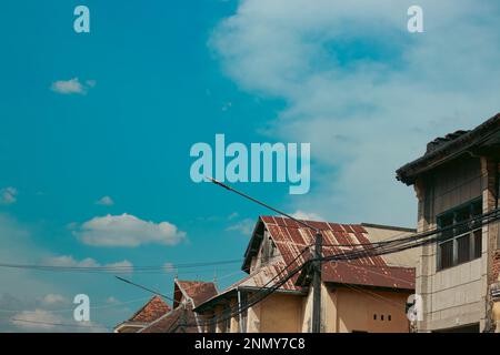 Low angle view of old vintage colonial houses against the summer blue sky in Kampot, Cambodia Stock Photo
