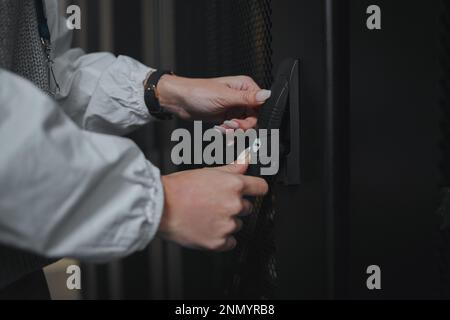 Entrance, hands and worker opening a server room for cyber security, programming and coding. Programmer, business and technician entering an office Stock Photo