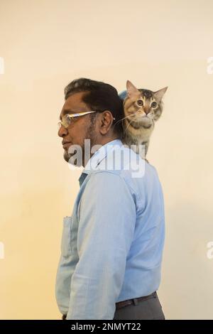 Dhaka, Bangladesh. 24th Feb, 2023. A cat owner shows off his pet cat during the cat ramp show at Jamuna Future Park in Dhaka. This is the first-ever cat ramp show where many cat lovers attended the events. Credit: SOPA Images Limited/Alamy Live News Stock Photo