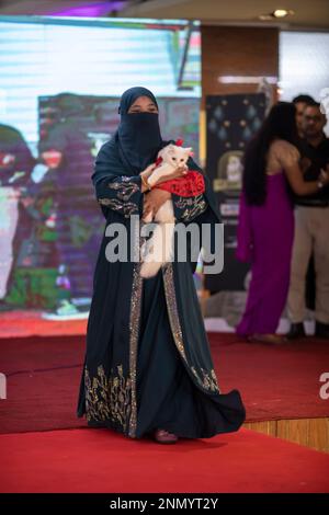 Dhaka, Bangladesh. 24th Feb, 2023. A cat owner shows off her pet cat during the cat ramp show at Jamuna Future Park in Dhaka. This is the first-ever cat ramp show where many cat lovers attended the events. Credit: SOPA Images Limited/Alamy Live News Stock Photo