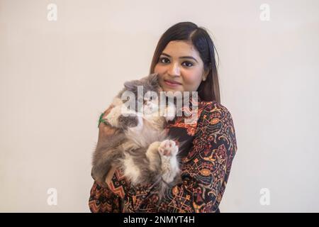 Dhaka, Bangladesh. 24th Feb, 2023. A cat owner shows off her pet cat during the cat ramp show at Jamuna Future Park in Dhaka. This is the first-ever cat ramp show where many cat lovers attended the events. Credit: SOPA Images Limited/Alamy Live News Stock Photo