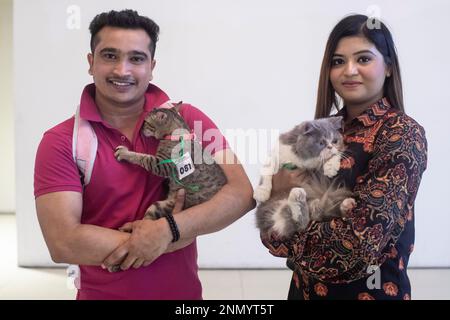 Dhaka, Bangladesh. 24th Feb, 2023. A couple shows off their pet cats during the cat ramp show at Jamuna Future Park in Dhaka. This is the first-ever cat ramp show where many cat lovers attended the events. Credit: SOPA Images Limited/Alamy Live News Stock Photo