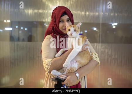 Dhaka, Bangladesh. 24th Feb, 2023. A cat owner shows off her pet cat during the cat ramp show at Jamuna Future Park in Dhaka. This is the first-ever cat ramp show where many cat lovers attended the events. (Photo by Sazzad Hossain/SOPA Images/Sipa USA) Credit: Sipa USA/Alamy Live News Stock Photo