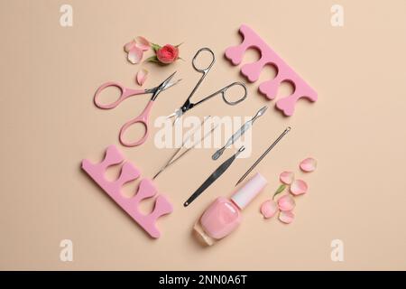 Composition with manicure and pedicure tools on beige background, flat lay Stock Photo