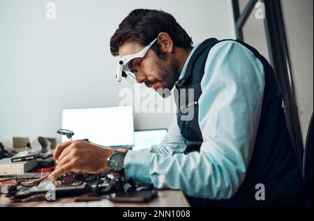 IT man, technician or magnifying glasses in motherboard fix, engineering workshop or database update. Worker, CPU or circuit board in repair Stock Photo