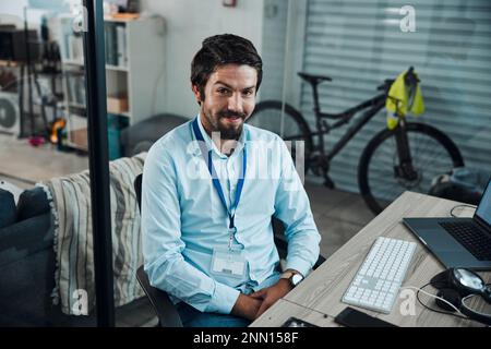 Man, portrait and IT technician in an office for computer software, technology or problem solving at desk. Happy engineer person doing maintenance Stock Photo