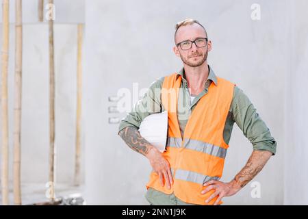 portrait builder professional engineer architect foreman hipster worker work in construction site, looking camera confident Stock Photo