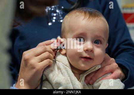 Baby being screened for hearing loss using otoacoustic emission test Stock Photo
