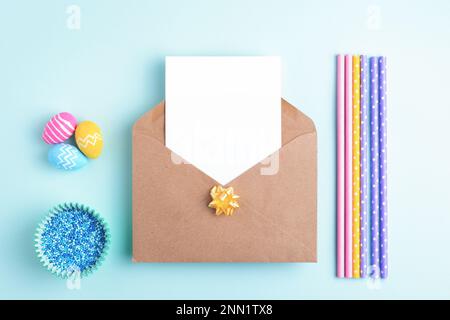 Easter background with empty card, easter eggs, holiday decoration. Flat lay, greeting concept, copy space. Stock Photo