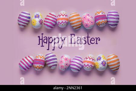 Colorful hand-decorated Easter eggs on a light blue background, arranged in two horizontal rows with copy space for a personalized Easter message. Use Stock Photo
