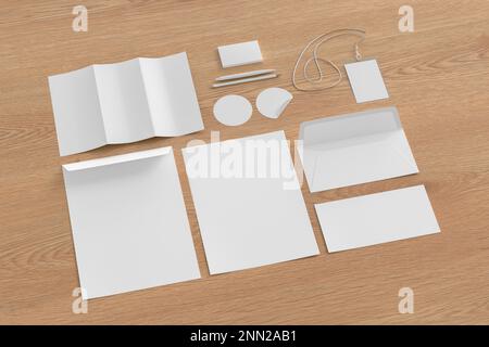 Blank corporate stationery set mockup with envelopes,  business cards, round stickers, trifold brochure, id card, pen and pencil  on wooden background Stock Photo