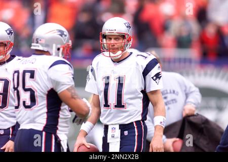 Members of the New England Patriots 2001 Super Bowl XXXVI team Lawyer Milloy,  left, and Drew Bledsoe, right, high five while standing on stage near  Patriots owner Robert Kraft, center, as they