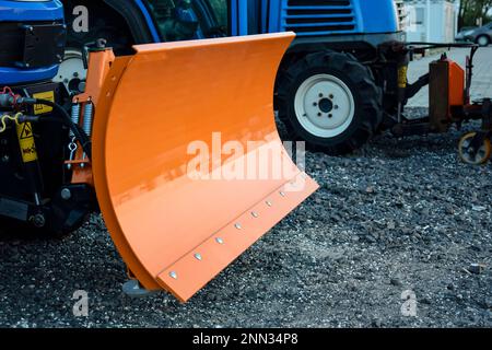 Orange snow digger bucket. Small snowblower. Snow removal equipment in anticipation of winter. Close-up. Selective focus. Copy space. Stock Photo