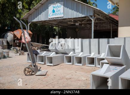 Biosand water filters awaiting finishing in the front yard of office for the charity Water for Cambodia in Siem Reap, Cambodia. Stock Photo