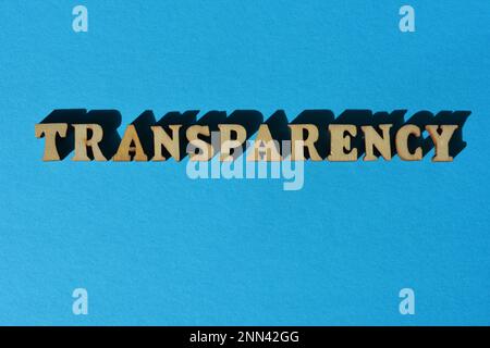 Transparency, word in wooden alphabet letters isolated on blue background Stock Photo