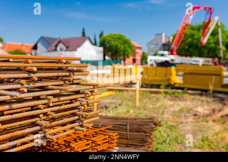 Pile of rusty rectangle steel reinforcement for concrete ready for installation placed at construction site. Stock Photo