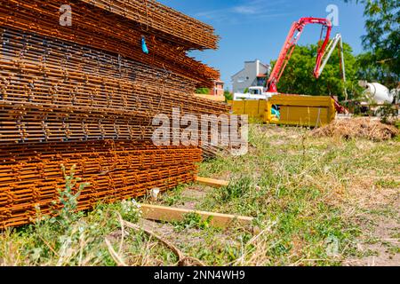 Pile of rusty rectangle steel reinforcement for concrete ready for installation placed at construction site. Stock Photo