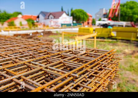 Pile of rusty rectangle steel reinforcement for concrete ready for installation placed at construction site. Stock Photo