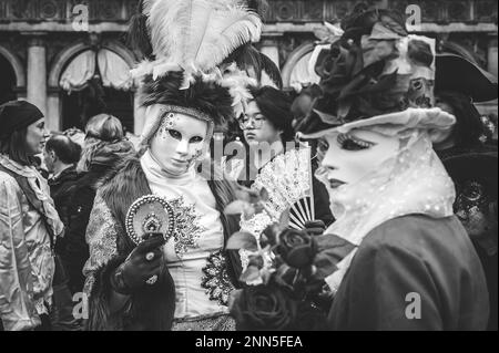 B/W portrait of a couple of carnival masked women in Venice Stock Photo ...