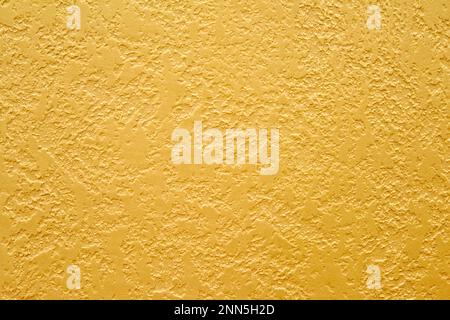 Texture of golden decorative plaster. Abstract grunge background for design. Stock Photo