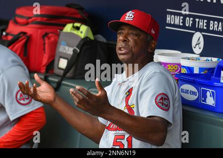 St. Louis Cardinals Hall-of-Famer Ozzie Smith gestures to his longtime  friend and teammate, assistant coach Willie McGee, on the Cardinals bench  before a baseball game between the Cardinals and the Kansas City