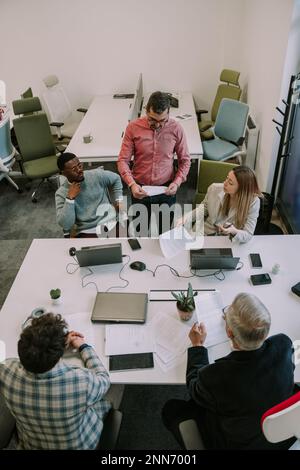 The boss telling his employees about their new job for the client at the office Stock Photo