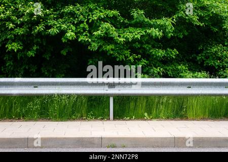 Closeup view of a metal guardrail and support posts along an urban ...