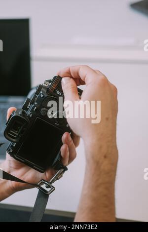 Close up of photographers hand putting back the sd card in his photo camera Stock Photo
