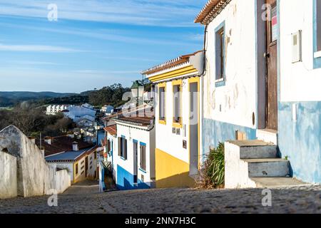 Traditional Portuguese houses with colourful facade. Street with whitewashed houses in the old town of Aljezur, Algarve, Portugal. Stock Photo