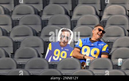 A Los Angeles Rams fan wearing an Aaron Donald jersey sits next to his  photo cutout during the Rams' NFL football practice in Inglewood, Calif.,  Thursday, June 10, 2021. (Keith Birmingham/The Orange