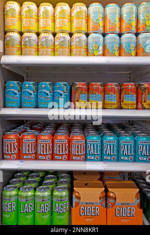 Vertical view of tins tin cans lager, pale ale, energy drinks on shelves in Tesco supermarket London England UK 2023  KATHY DEWITT Stock Photo