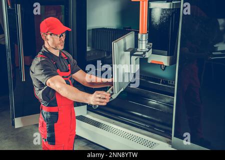 Professional Industrial Laser Cutting Machine Operator at His Workplace. Manufacturing and Producing Industry. Stock Photo
