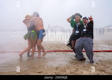 Ahlbeck, Germany. 25th Feb, 2023. Members of ice bathing clubs from Germany and Poland take a so-called ice shower on the beach in front of the pier. Storm and waves had prevented swimming in the Baltic Sea. The winter weather is currently cold and wet in northern Germany. Credit: Stefan Sauer/dpa/Alamy Live News Stock Photo