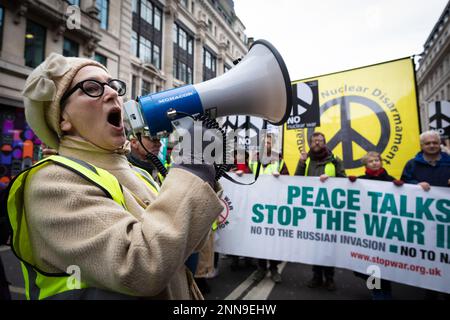 London, UK. 25th Feb, 2023. Stop The War supporters march through the city for a national demonstration. A year ago, Russia invaded Ukraine, resulting in thousands of people being killed. The Stop The War movement wants to see peace talks happen, not the arming of an ongoing war which only benefits arms manufacturers. Credit: Andy Barton/Alamy Live News Stock Photo