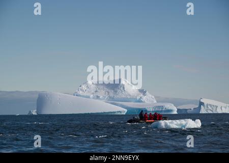 Tourists cruising among icebergs in Antarctica