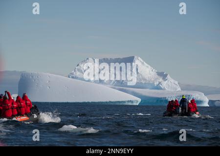 Tourists cruising among icebergs in Antarctica
