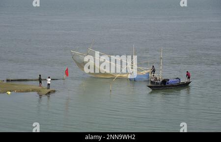 Guwahati, Guwahati, India. 25th Feb, 2023. Fisherman spread his fishing net in river Brahmaputra which flows from China, Tibet and enter India in Guwahati Assam India on Saturday 25th February 2023. (Credit Image: © Dasarath Deka/ZUMA Press Wire) EDITORIAL USAGE ONLY! Not for Commercial USAGE! Stock Photo