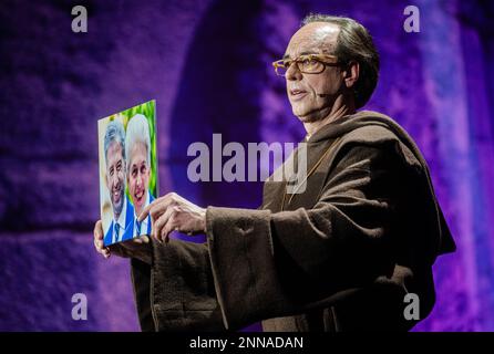 Fellbach, Germany. 25th Feb, 2023. Cabaret artist Christoph Sonntag presents his program 'Das jüngste Gerü/icht mit Bruder Christophorus Sonntag' in the Alte Kelter and holds a picture of politicians Boris Palmer and Marie-Agnes Strack-Zimmermann in his hand during the recording as an SWR broadcast. The program will be broadcast on 26.02.2023 at 20.15. Credit: Christoph Schmidt/dpa/Alamy Live News Stock Photo
