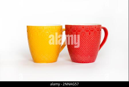 Two colorful mugs isolated on white background Stock Photo
