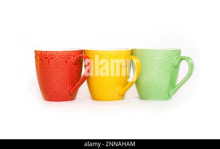 Three colorful mugs isolated on white background Stock Photo