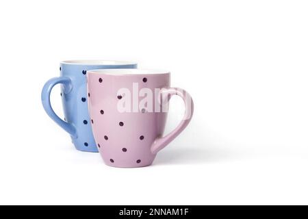 Pink and blue dotted mugs isolated on white background with copy space Stock Photo