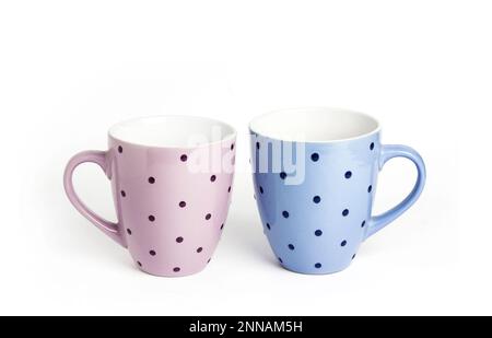 Pink and blue dotted mugs isolated on white background with copy space Stock Photo