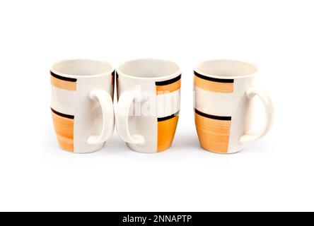 Stack of three mugs isolated on white background with clipping path Stock Photo