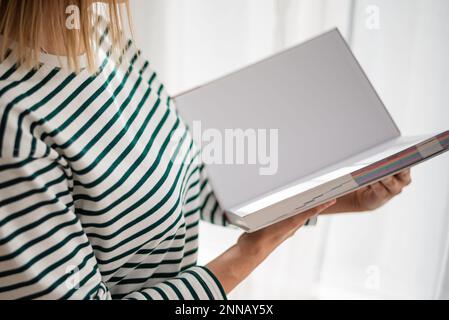 Opened book in hands isolated on white background. Stock Photo