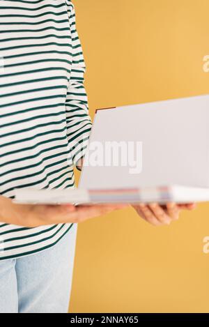 Opened book in hands isolated on white background. Stock Photo
