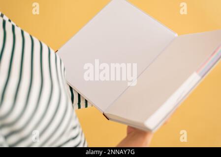 Opened book in hands isolated on white background. Stock Photo