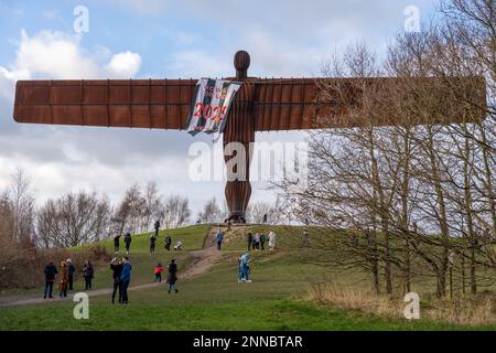 Gateshead, UK. February 25th, 2023. Landmark sculpture, Antony Gormley's  Angel of the North draped in a Newcastle United flag reading, 'Howay the Lads 2023 Wembley', as the men's football team head to Wembley Stadium to take on Manchester United in the Carabao Cup final tomorrow. The black and white striped flag is thought to have been erected by fans' group Wor Flags as they headed South for the match in the early hours of Saturday morning. Credit: Hazel Plater/Alamy Live News Stock Photo