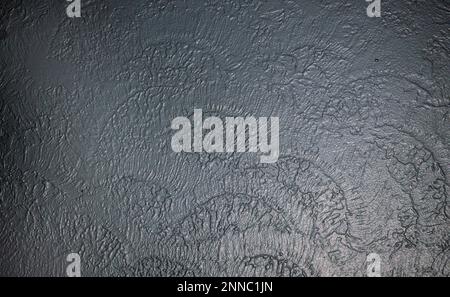 A freshly painted grey wall on a textured plaster surface. Nice detail in the soft surface texture finish. Stock Photo